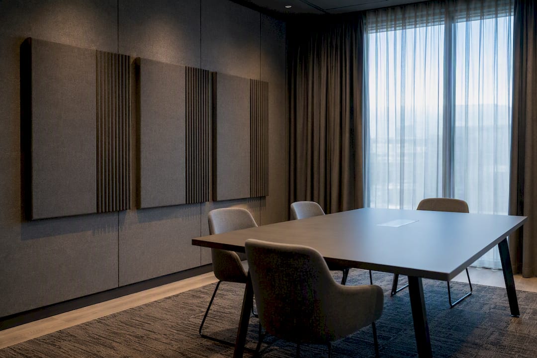 Meeting room with acoustic panels rug curtains